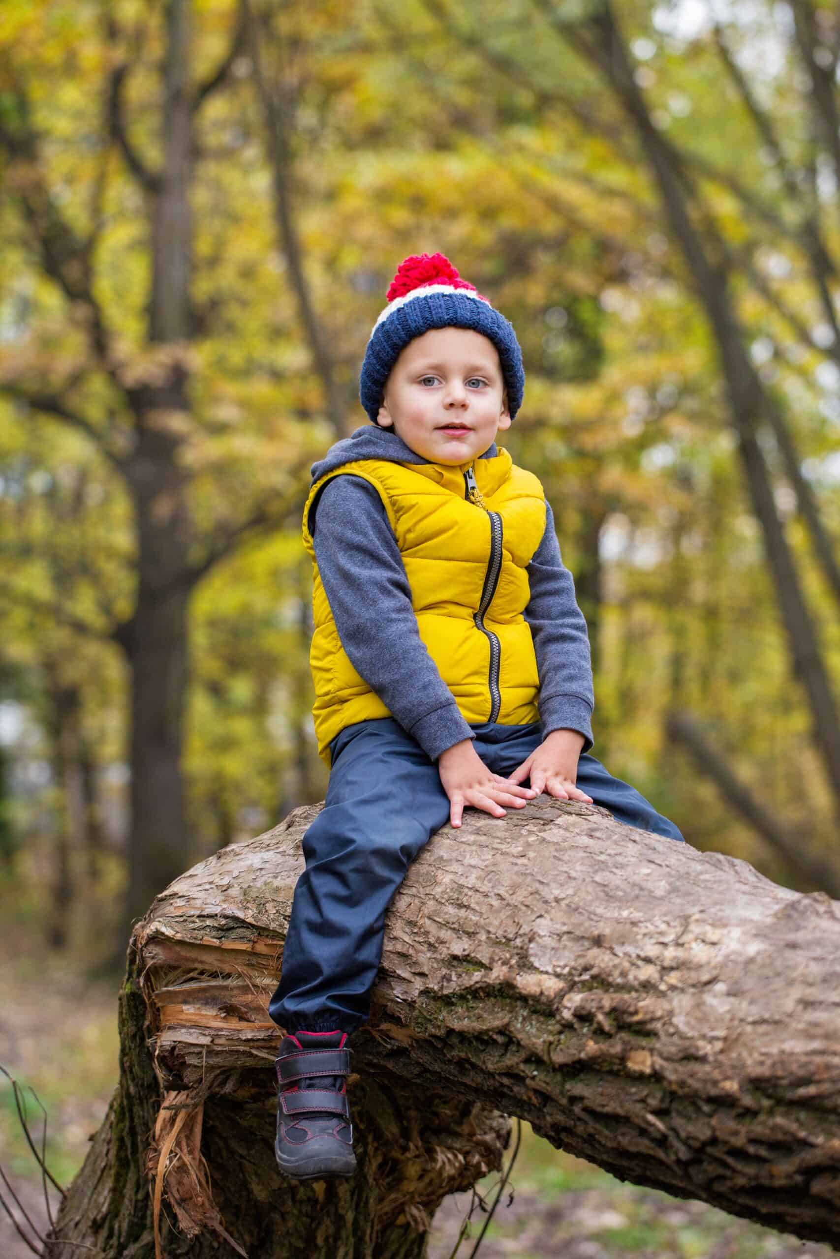 Child sitting on a log