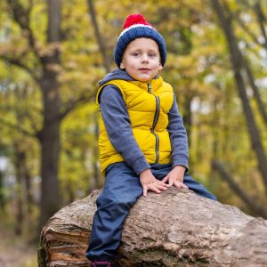 Child sitting on a log